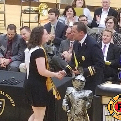 Graduating senior accepting scholarship from Community Outreach