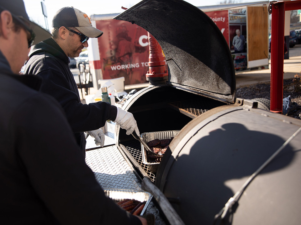 Firefighters manning the grill at a community BBQ