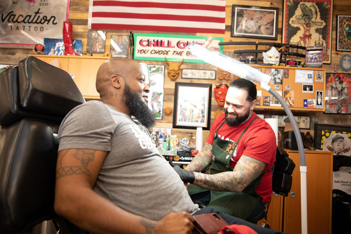 Man getting a tattoo for Toys for Tats